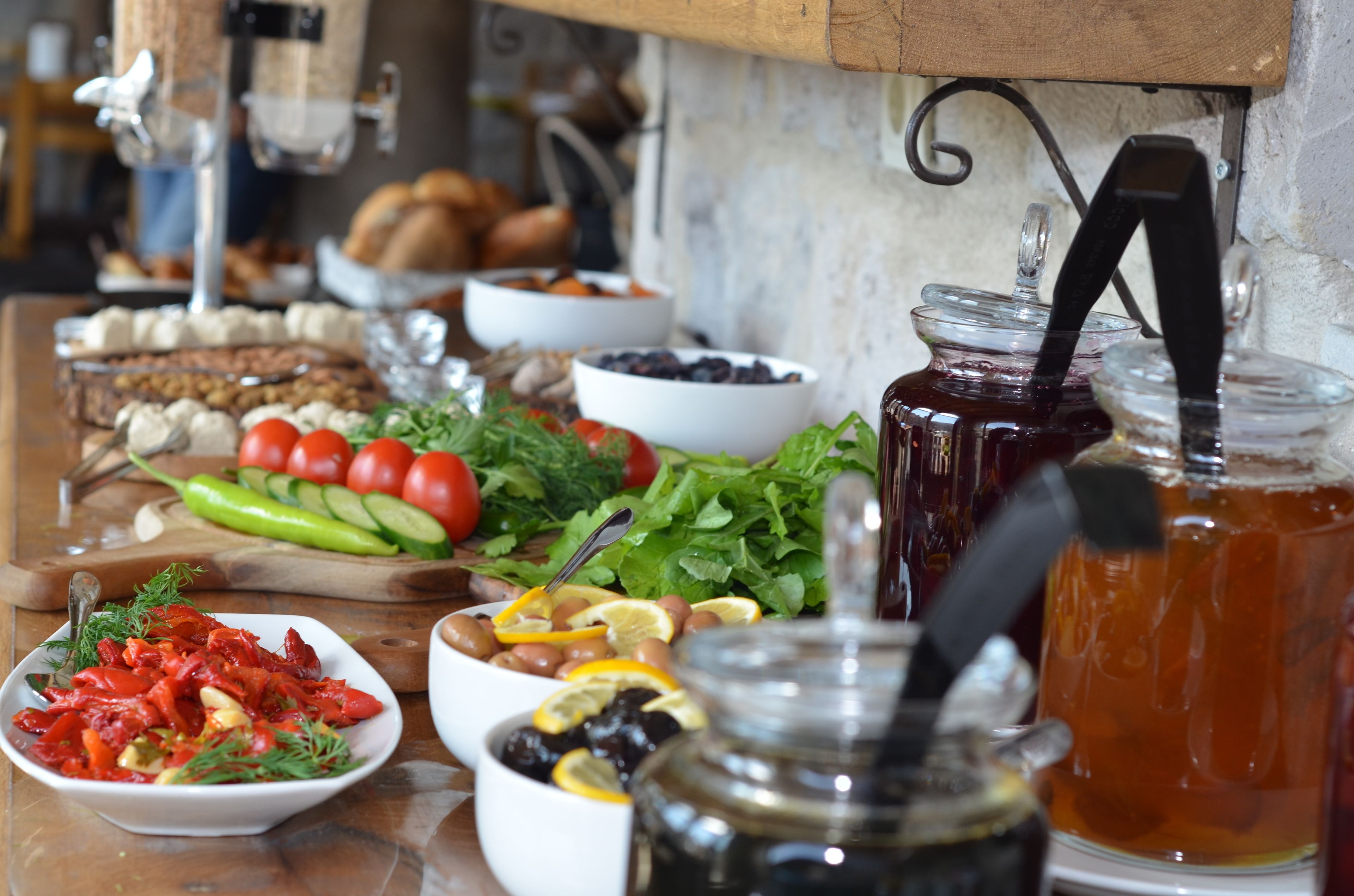 A table with various food items and a jar of honey.
