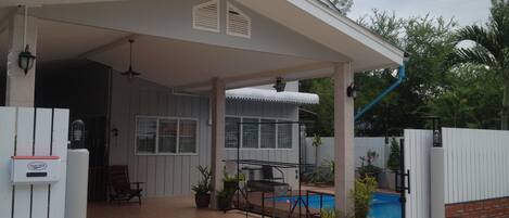 Enjoy outdoor dining and social gatherings on the covered patio with a grill and seating.