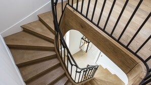 A wooden staircase with black railings and a white wall. - Haut-Bailly - La Chartreuse - Anciennement Château Le Pape (Leognan)