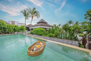 A pool with a floating bar and a wooden fence surrounding the area. - The Palayana Hua Hin (Cha-am)