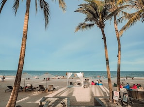 Na praia, areia branca, guarda-sóis, bar na praia 