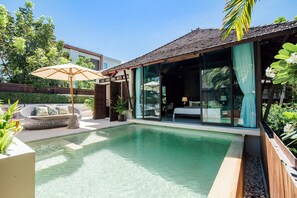 A modern pool area with a glass-enclosed room, outdoor seating, and a wooden deck. - The Palayana Hua Hin (Cha-am)