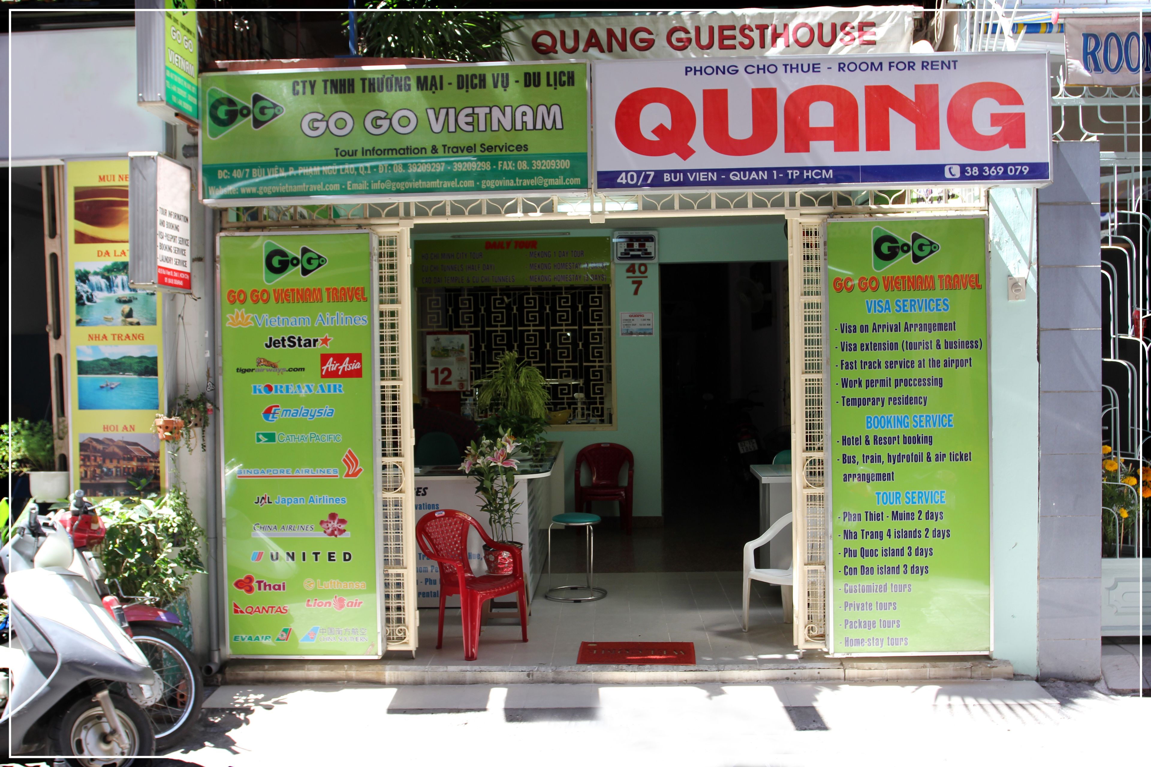 A travel agency named 'QUANG' with signs for 'GO GO VIETNAM' and 'GO GO VIETNAM TRAVEL'.