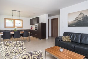 Apartment, 3 Bedrooms, Kitchen, Mountain View | Living area | Flat-screen TV, heated floors