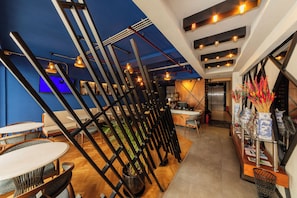 A modern interior with a bar area, seating, and a reception desk. - Redmont Hotel Nisantasi (Istanbul)