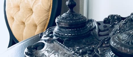 A close-up of an ornate metal tray with intricate designs, placed on a dark wooden table.