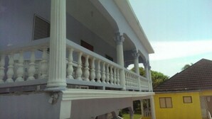 A two-story house with a balcony supported by columns and balusters. - Ocho Rios Pimento Villas (Ocho Rios)