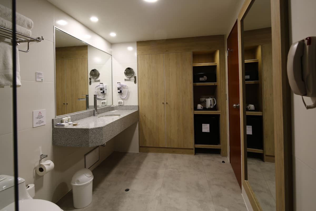 junior suite, 1 king bed | bathroom | shower, designer toiletries, hair dryer, towels