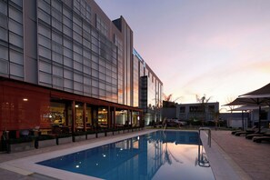 Un hotel moderno con piscina, terraza y restaurante.