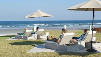 Relax on the beachside patio with comfortable lounge chairs and umbrellas.