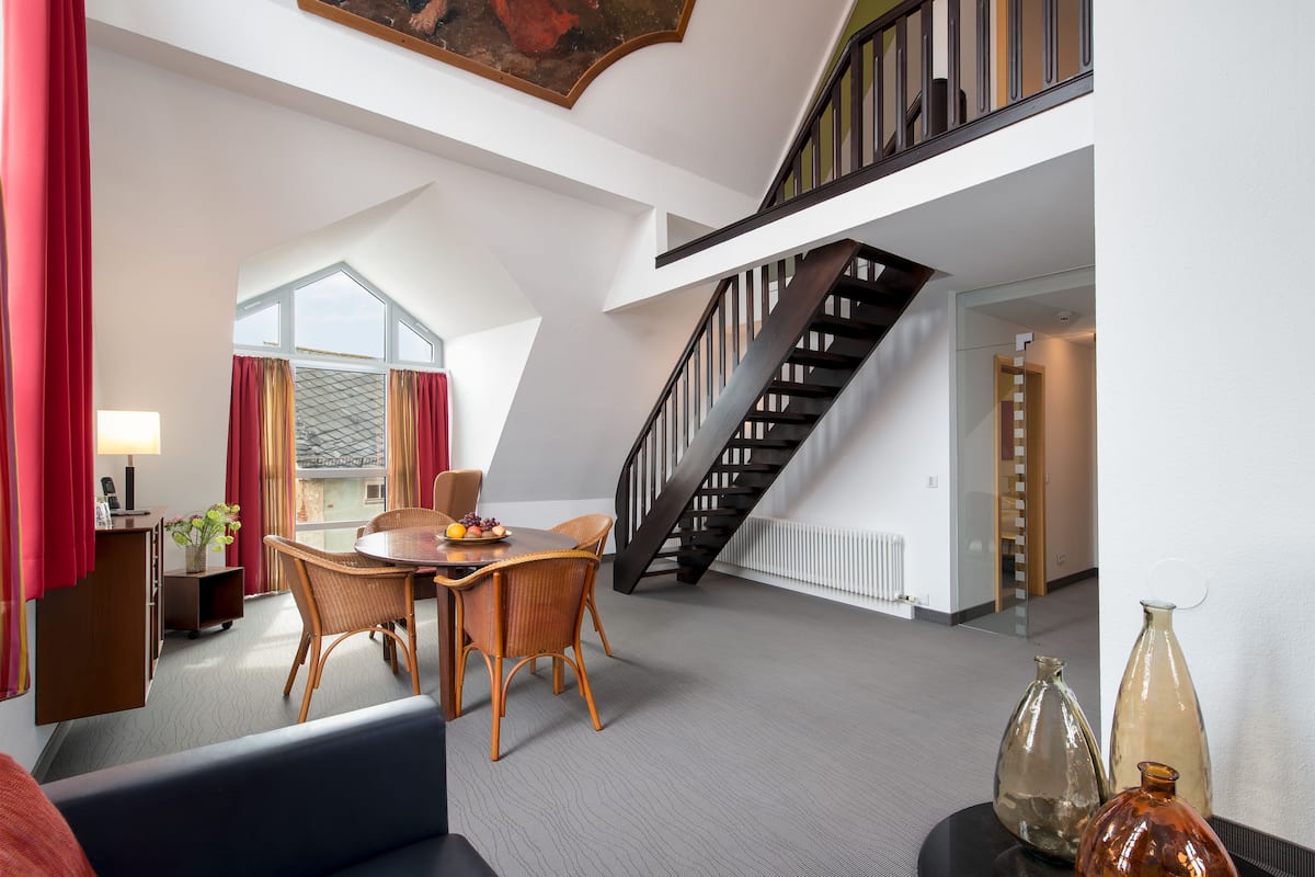 exclusive suite, 2 bedrooms, hot tub, river view | living area | flat-screen tv