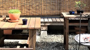 A wooden table with a potted plant and a blue cup. - Hostel Mt. Fuji-FUKUYA (Fujiyoshida)