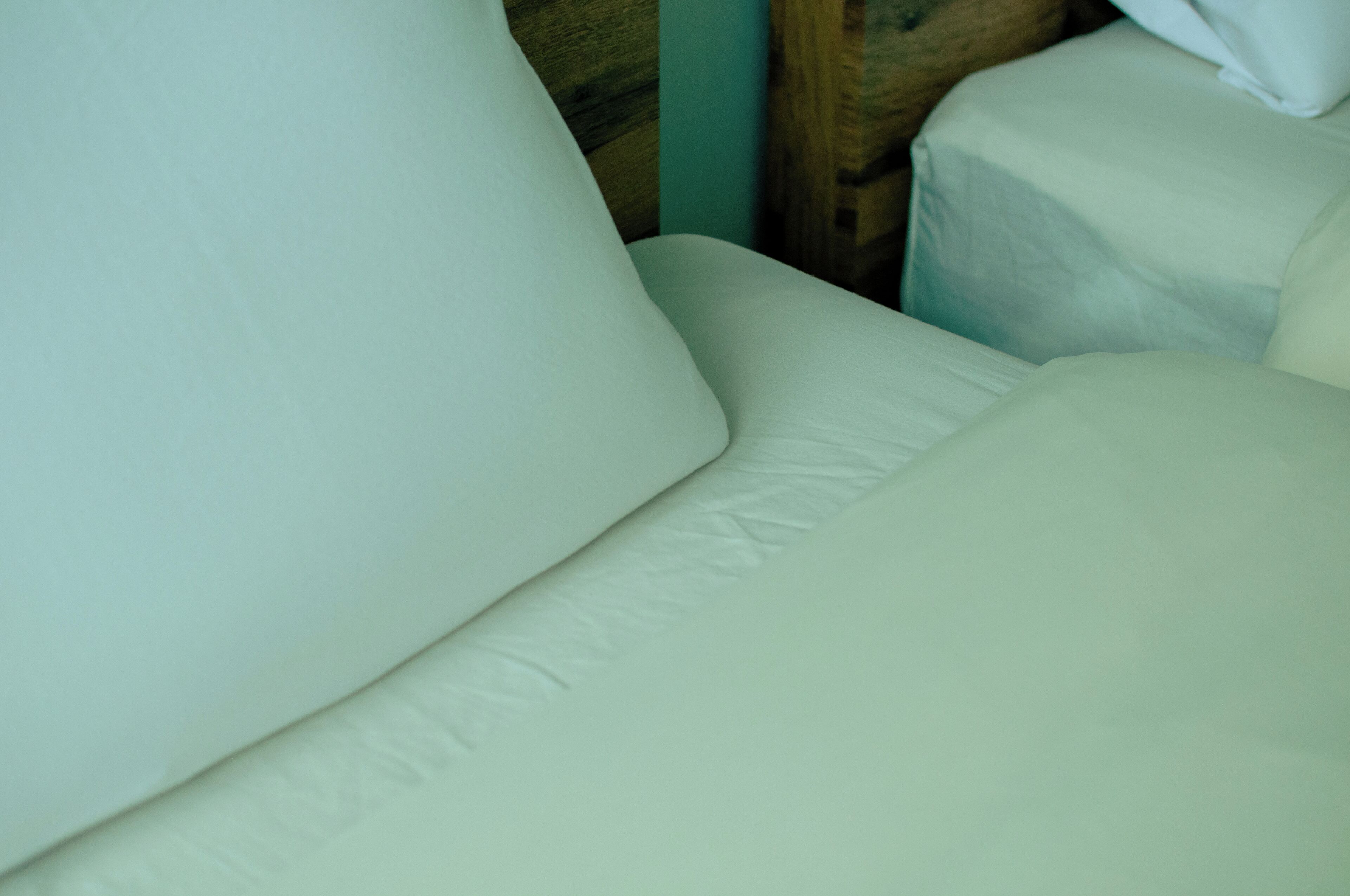 A close-up of a white upholstered sofa with a textured fabric.