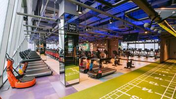 A gym with treadmills, stationary bikes, and weight machines.