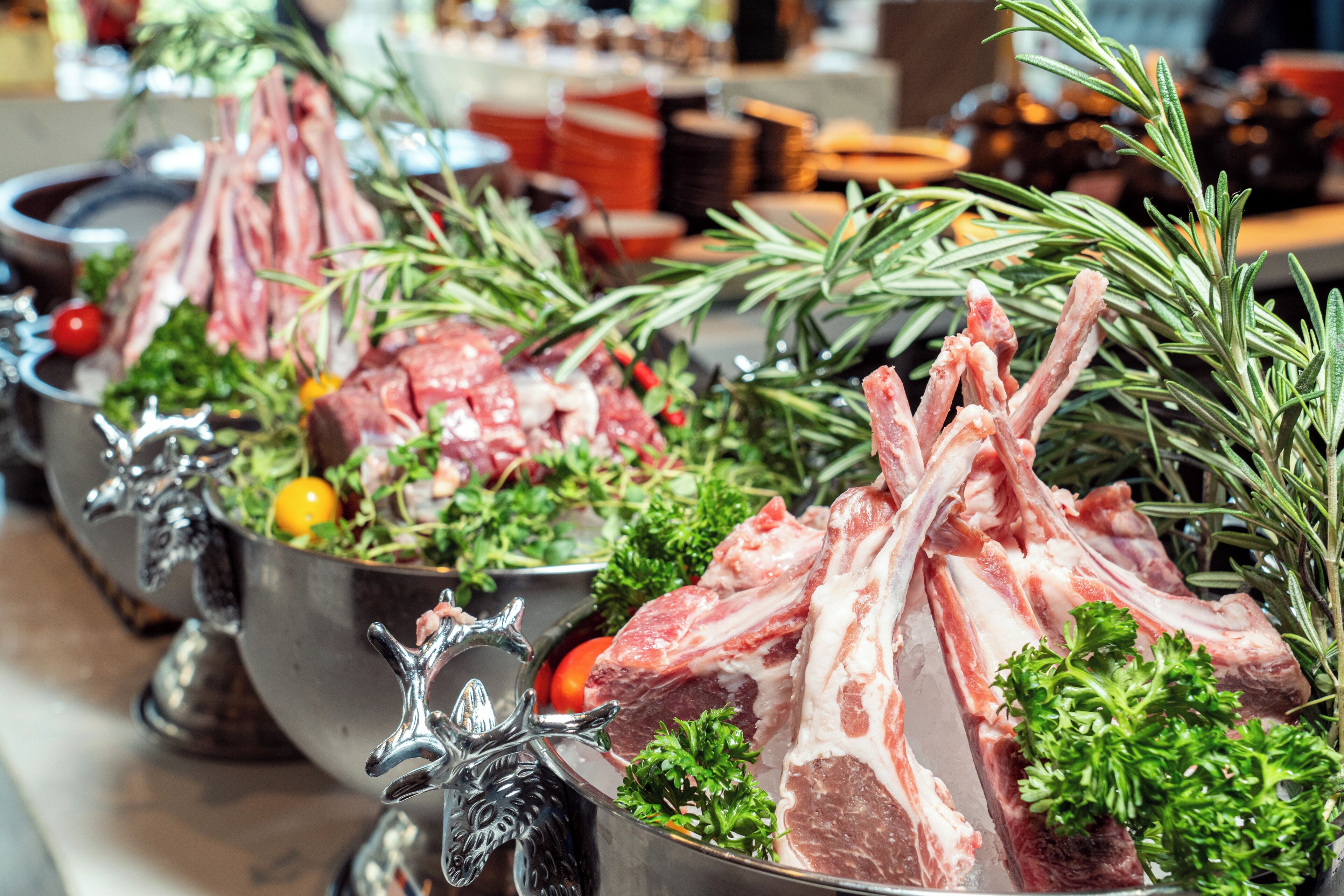 A buffet with various meats and vegetables.