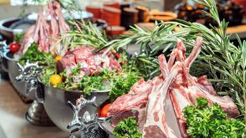 A buffet with various meats and vegetables.