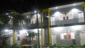 A multi-story building with balconies and doors marked with room numbers. - Bromo Sunrise Homestay (Probolinggo)
