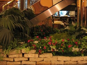 A staircase with a stone wall and plants. - Noble Hotel (Kaohsiung)