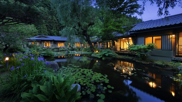 A traditional Japanese-style building with a koi pond and lush greenery. - Tachibanaya (Tsuruoka)