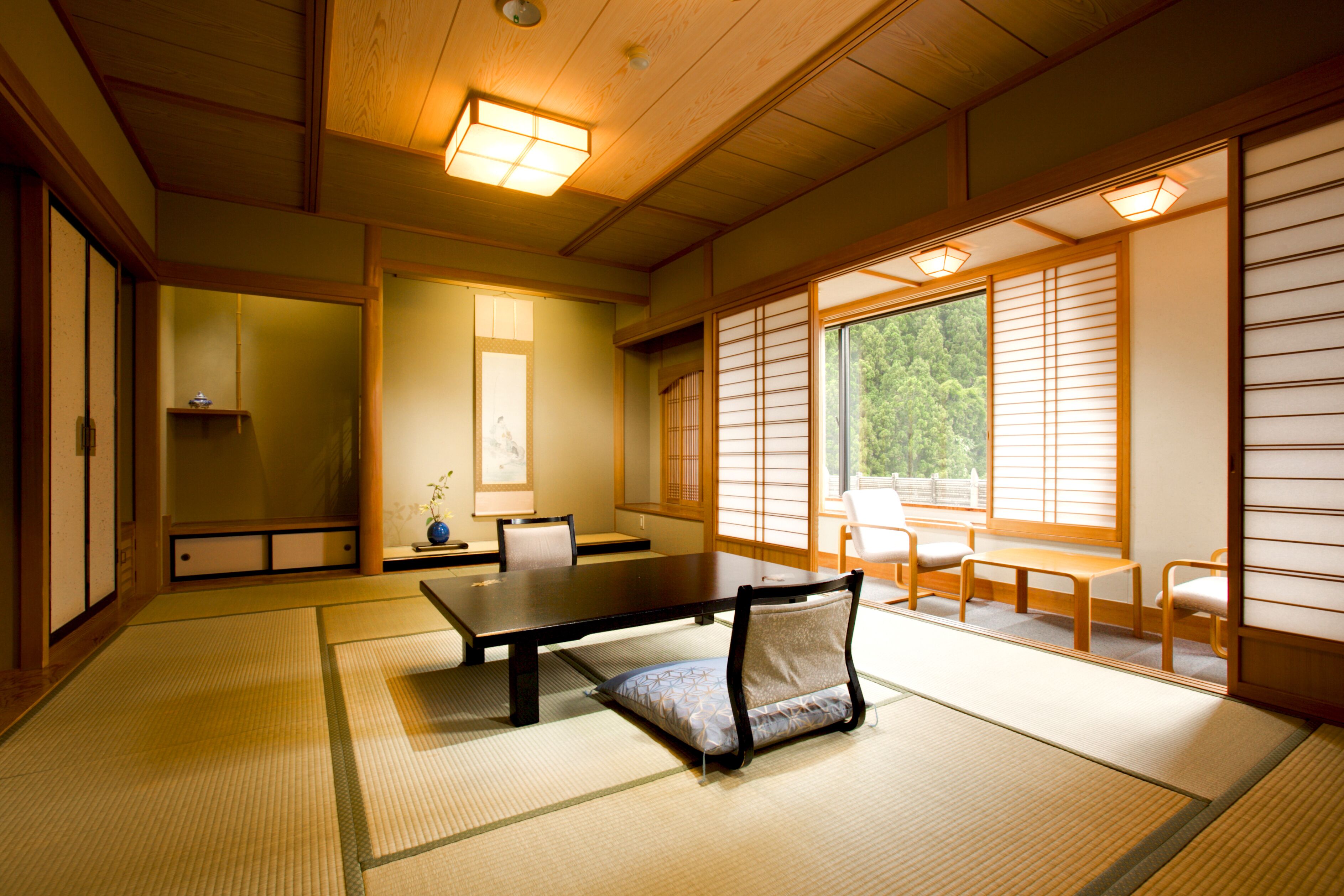 A traditional Japanese room with tatami flooring, a low table, and shoji screens.