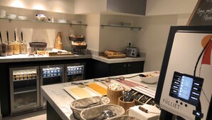 A modern kitchen with a marble countertop, equipped with a coffee machine, toaster, and various food items. - Staycity Aparthotels, Lyon Rue Garibaldi (Lyon)