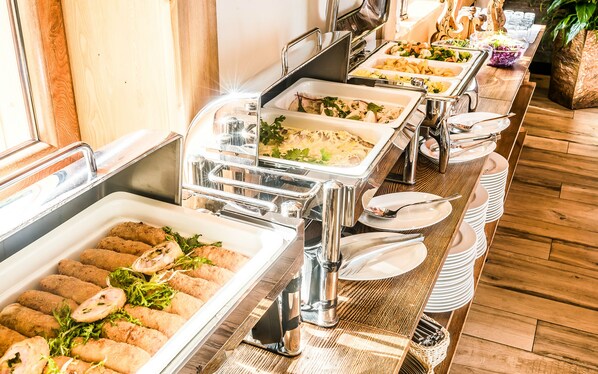 Un bufé con diferentes alimentos y utensilios.