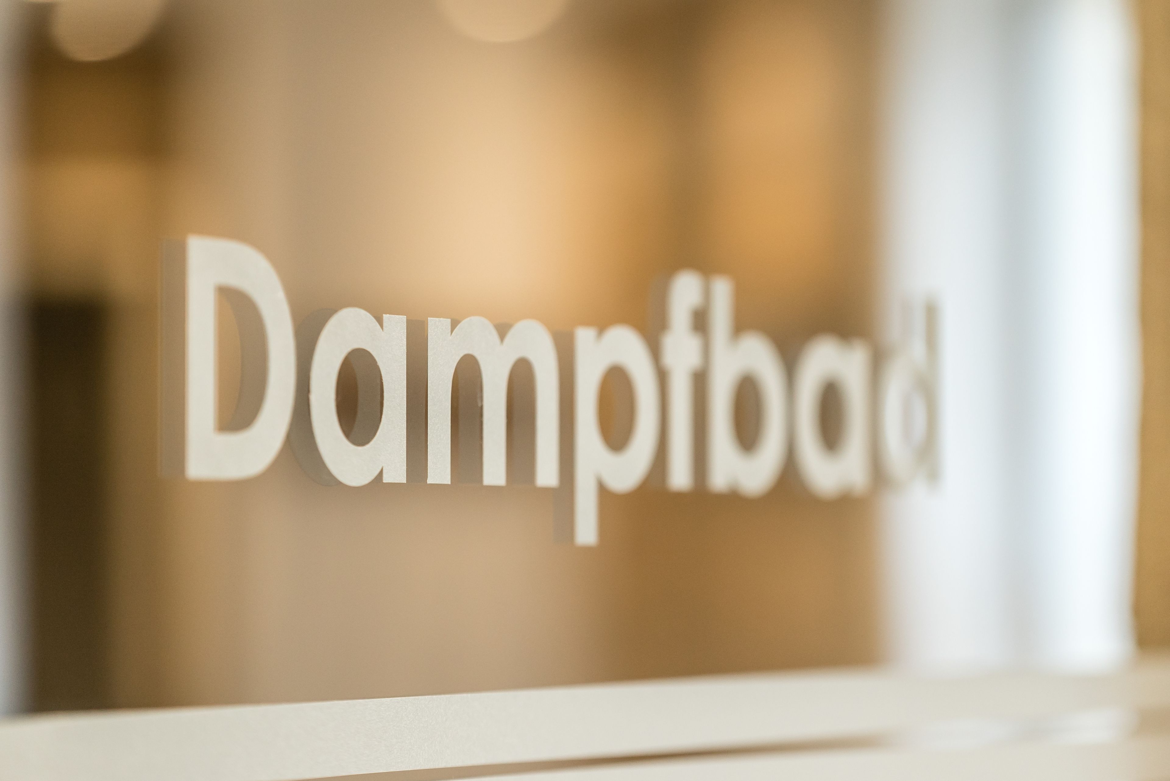 A close-up of a sign with the text "Dampfbad".