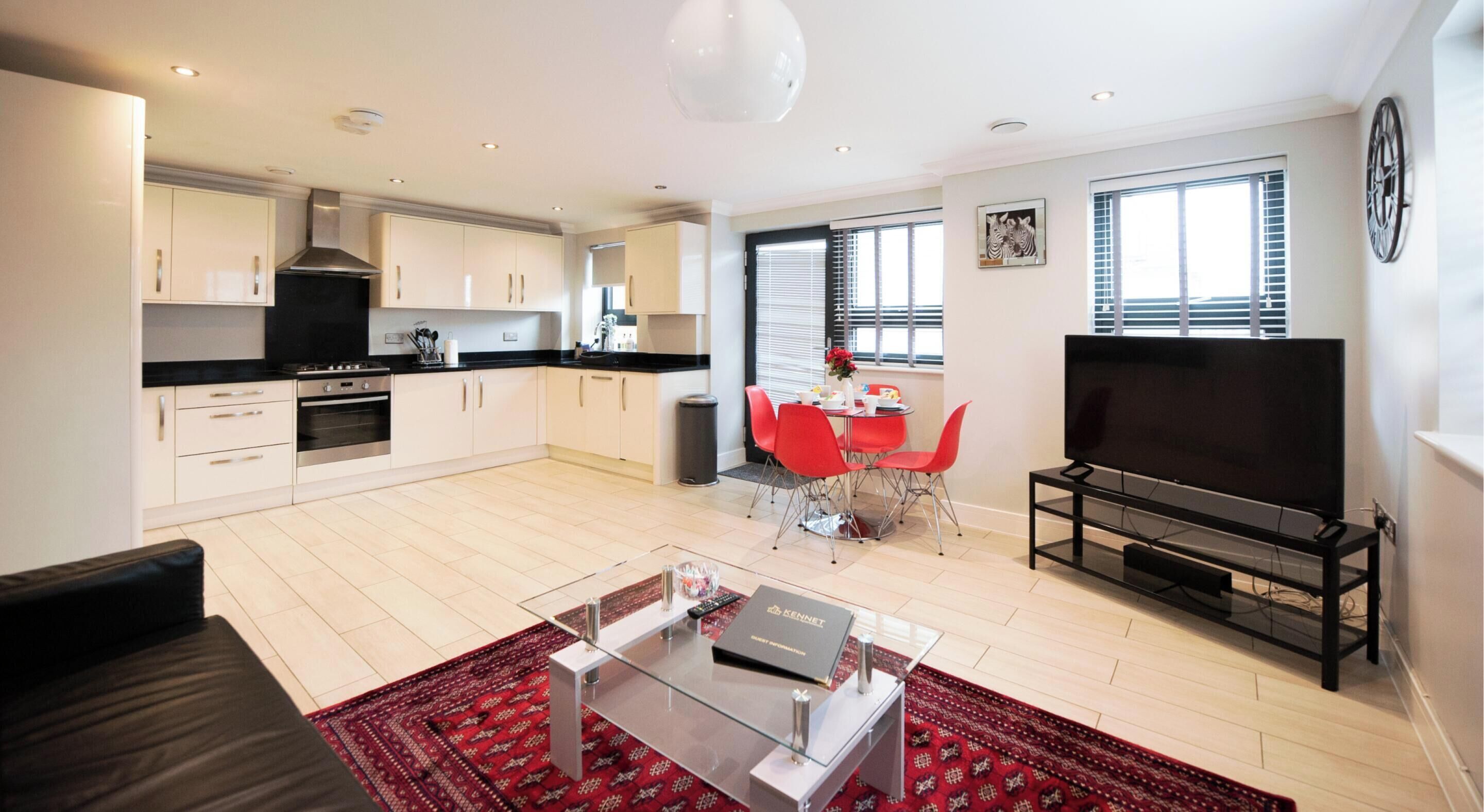 A modern apartment with a kitchen, dining area, and living room.