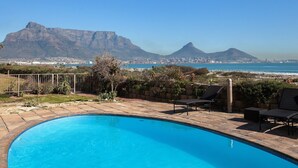 A swimming pool with a view of a cityscape and mountains. - Leisure Bay 306 by CTHA (Cape Town)