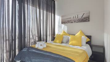 2 bedrooms, premium bedding, laptop workspace, iron/ironing board