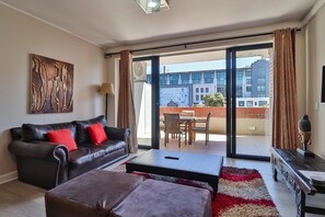 Panoramic Apartment | Living area | 55-inch flat-screen TV with digital channels, TV, streaming services - Rockwell Apartments by CTHA (Cape Town)