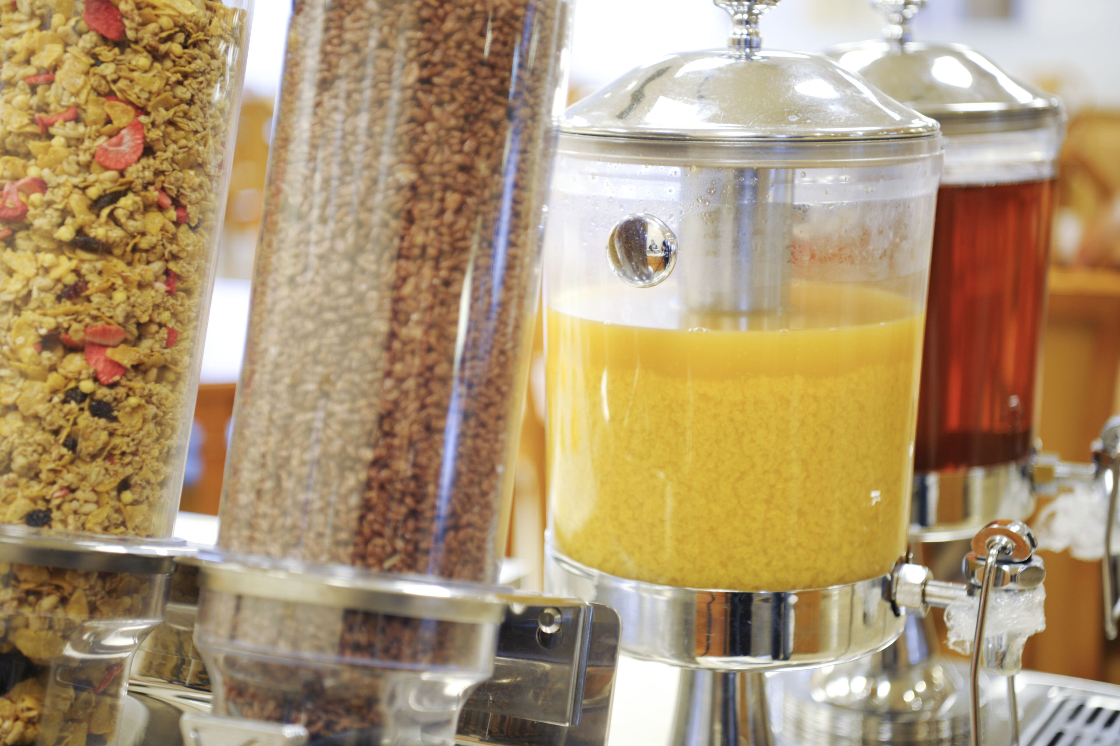 A beverage dispenser with multiple options including a clear liquid and a yellowish liquid.