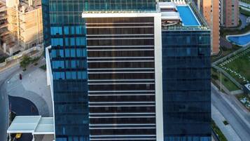 A modern building with a glass facade and a sign reading 'CROWNE PLAZA'.