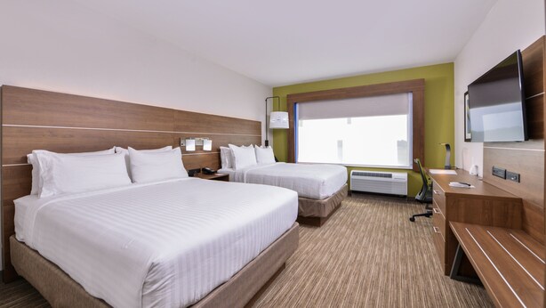 A hotel room with two beds, a TV, a desk, and a window with blinds. - Holiday Inn Express & Suites Siloam Springs by IHG (Siloam Springs)