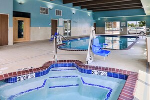 A pool area with multiple pools, diving boards, and lifebuoys.