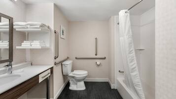 A modern bathroom with a toilet, sink, and shower.