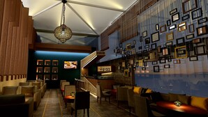 Un interior moderno con una zona de bar, asientos y una escalera.