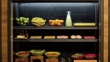 A kitchen with various food items and kitchenware.