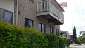 A two-story motel with a balcony on the second floor, surrounded by greenery. - Goomeri Motel (Goomeri)