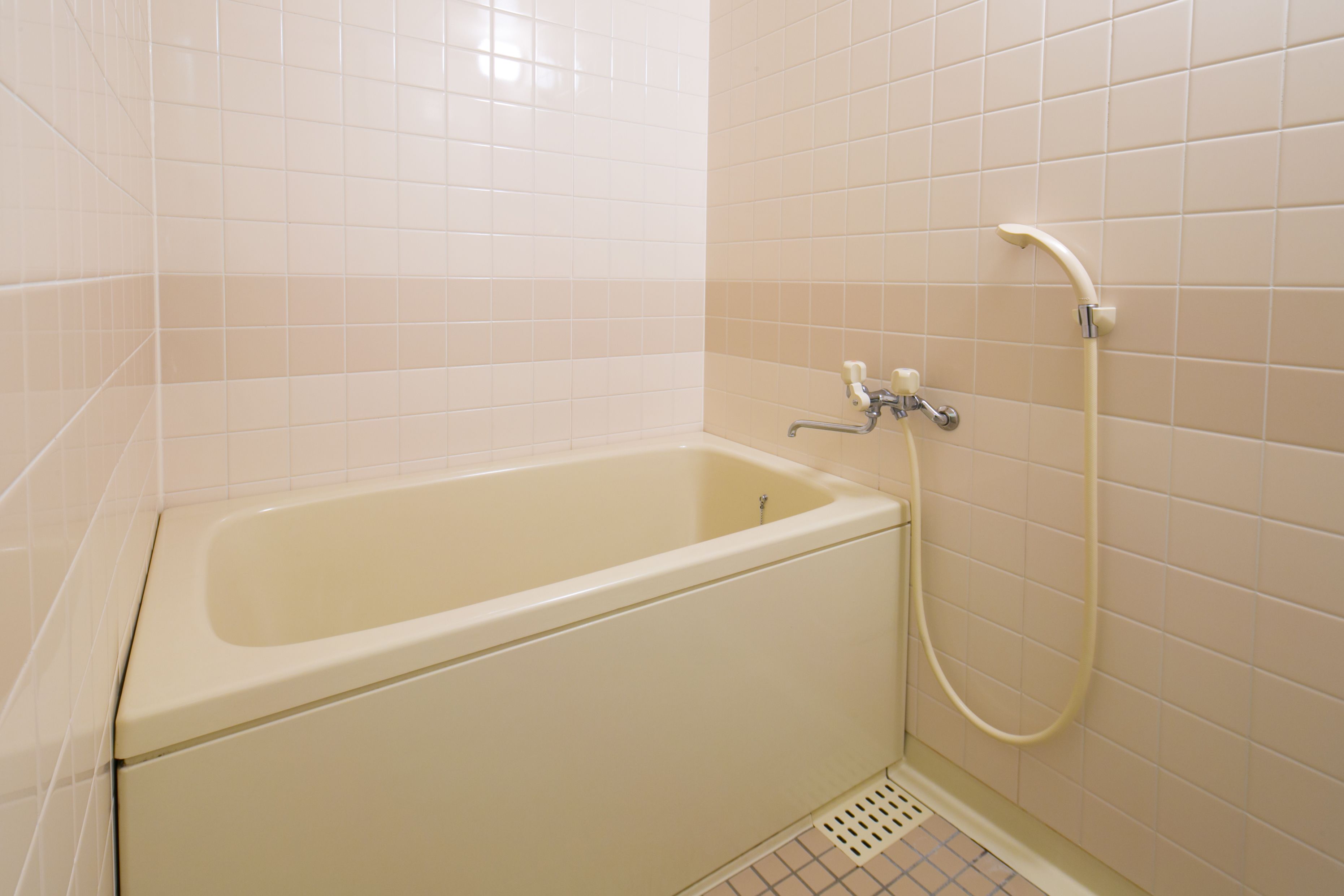 A standard bathroom with a bathtub, a shower, and a toilet.
