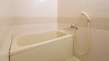 A standard bathroom with a bathtub, a shower, and a toilet.