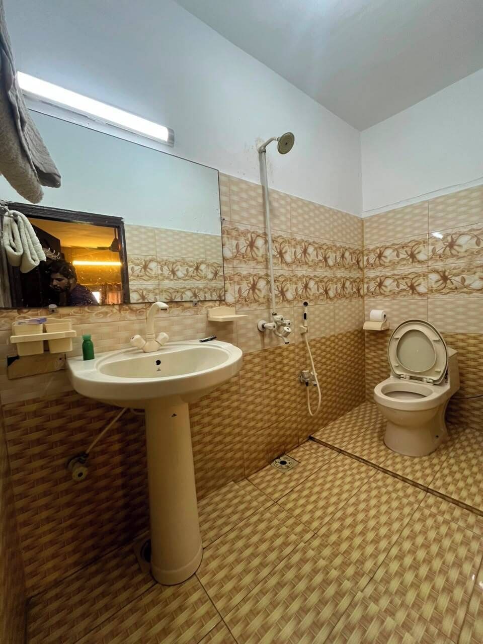 Un baño con lavamanos, inodoro y ducha.