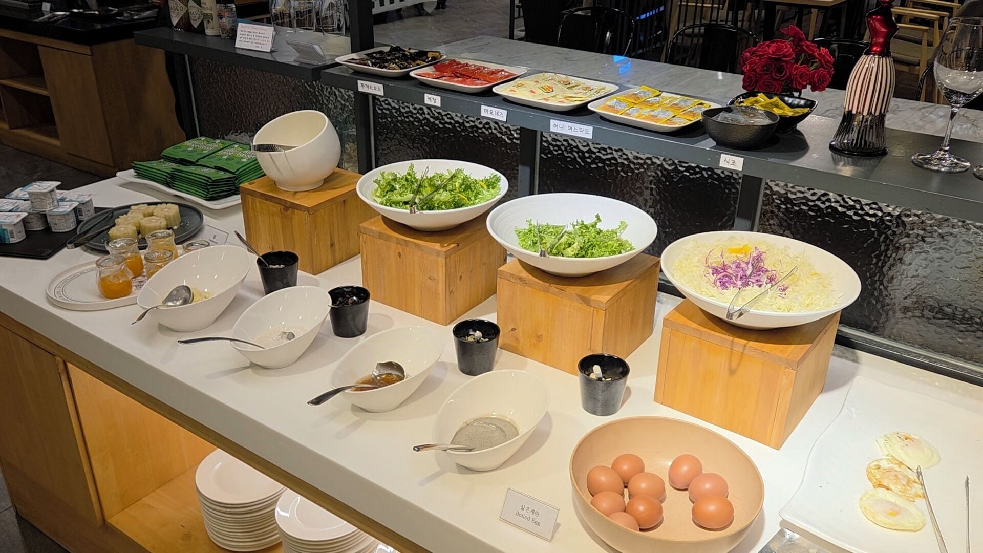 A buffet with various food items including salads, boiled eggs, and other dishes.