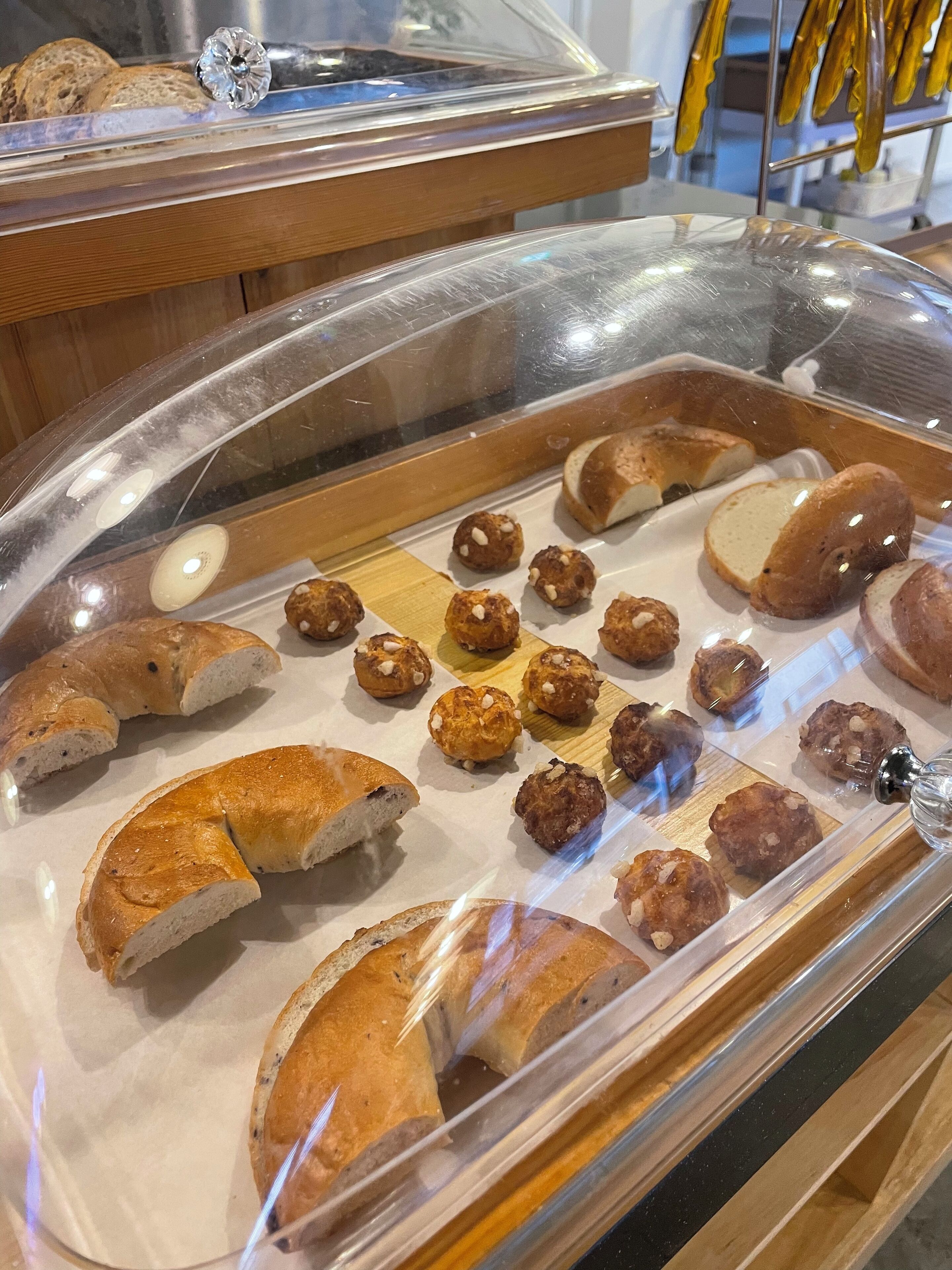 A bakery display case with various baked goods, including bread and pastries.