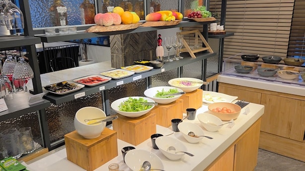 A buffet setup with various food items and utensils. - JB Plus Hotel (Busan)