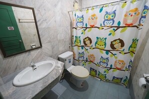 A bathroom with a white sink, toilet, and shower curtain featuring owl and branch designs. - Luxury Hotel (Kanchanaburi)