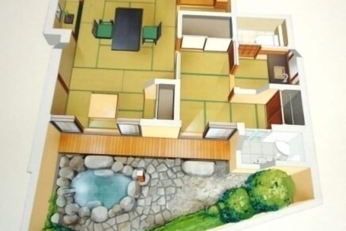 Un edificio de dos pisos con piscina, jardín y patio.