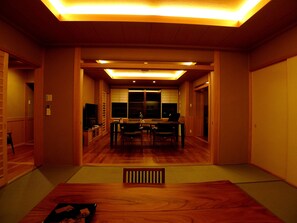 A traditional Japanese-style room with a tatami mat floor, a low table, and a television. - Suihouen (Gero)
