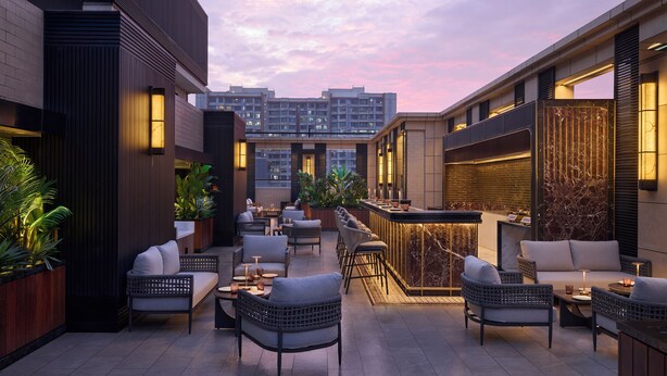 A rooftop bar with outdoor seating, including sofas and chairs, and a bar counter. - The Fern Mumbai, Goregaon, Series by Marriott (Mumbai)