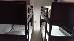 A bunk bed room with two beds, each with white bedding. - Amazon Guesthouse - Hostel (Seoul)